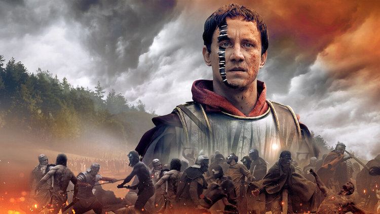 Poster of Barbarians, a 2020 German historical war drama television series, with soldiers fighting with each other starring Laurence Rupp as Arminius with a serious face, with paint and blood on his face, and wearing armor.