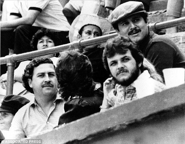Pablo Escobar at the left and Jorga Luis Ochoa wearing a hat at the bullfight in Medellin, Colombia