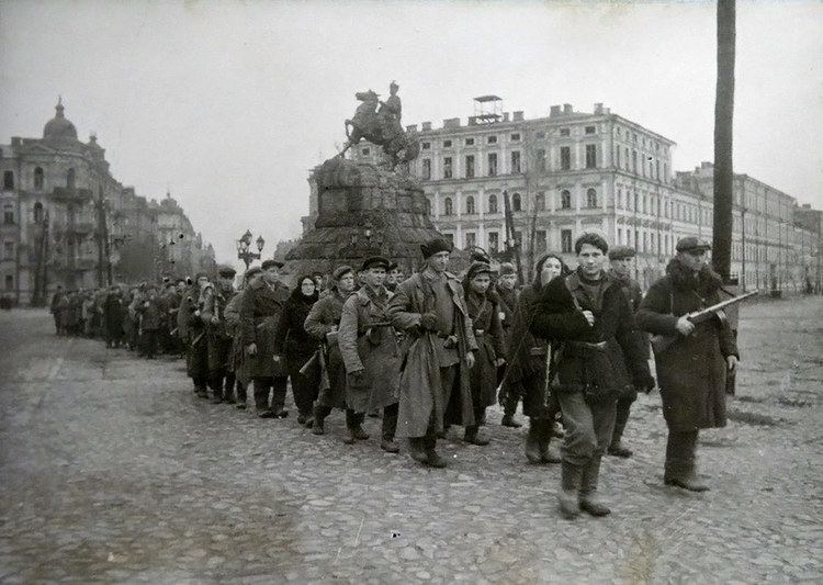 Ukrainian Red Partisans marching past the statue of Bohdan Khmelnytsky during the liberation of Kyiv, in 1943.