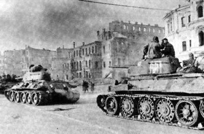 Tank platoons containing Ukrainian soldiers with buildings in the background