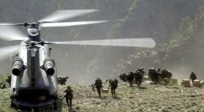 Soldiers coming out of a helicopter during the Battle of Tora Bora as the battle ensues.