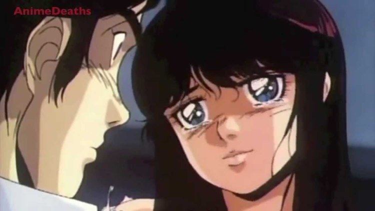 In a clip of the 1986 animation movie “Battle Royal High School”, a man (left) seriously looks at the girl with a side view post and the girl (right) was crying with her black hair with bangs, the man has black hair wearing a white polo
