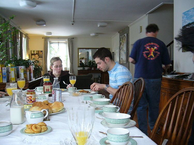 A man and a woman eating at the Bed and breakfast