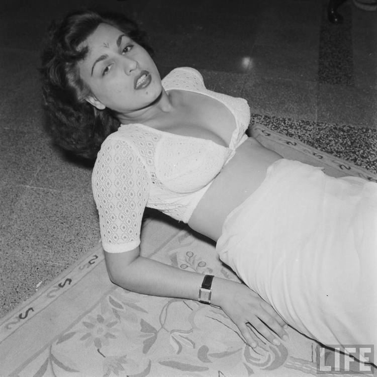 Begum Para lying on the floor while wearing white sexy top and white skirt