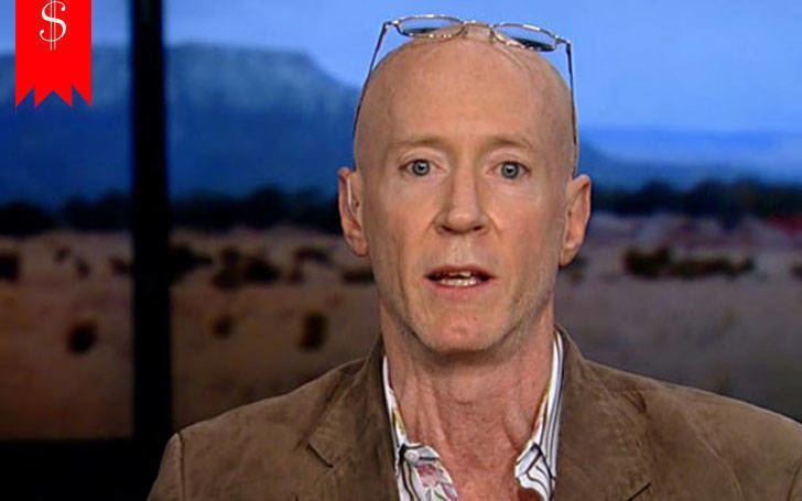 Bernard McGuirk with eyeglasses on his bald head, wearing a brown suit.