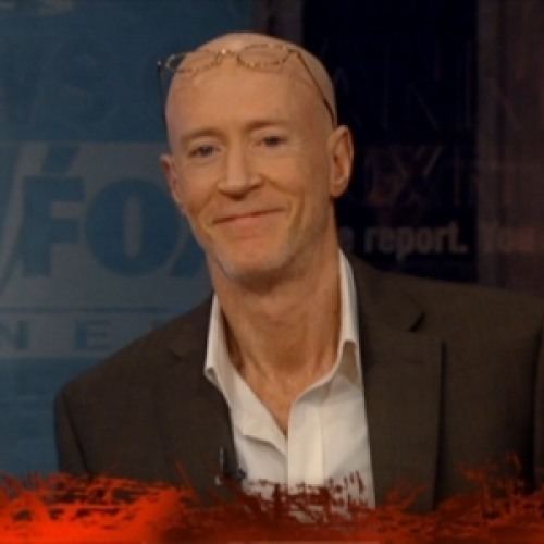 Bernard McGuirk with eyeglasses on his bald head, wearing a suit and a white shirt.