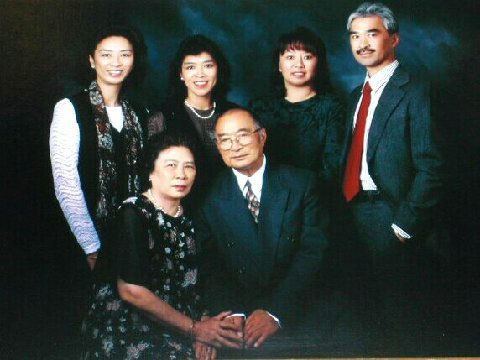 Betty smiling while standing with Gloria, Cathie, Harry Ong, and their mother and father sitting in the front