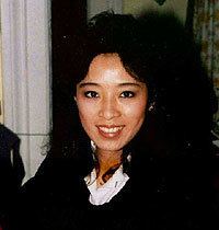 Betty Ong smiling while wearing a black and white blouse