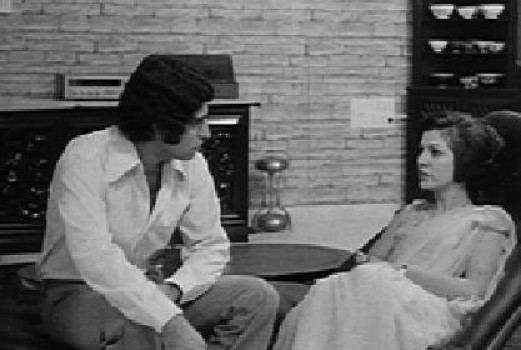 A man and a woman talking to each other in a scene from the 1976 film Beyond the Last Mountain