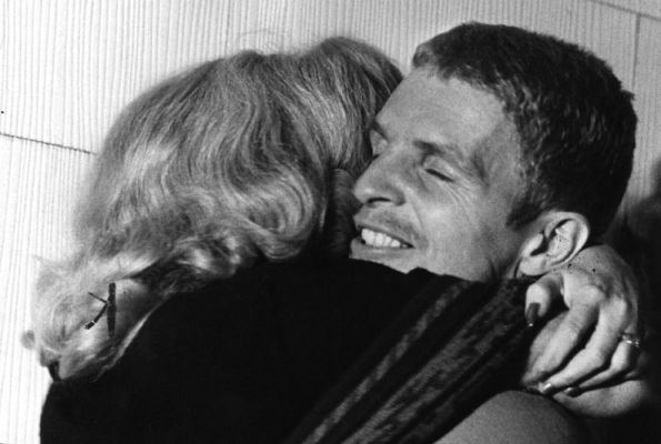 Billy Hayes smiling while the woman hugging him