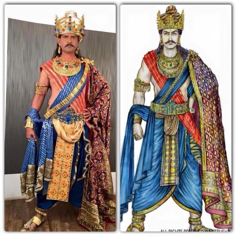 On (left) is Bindusara Maurya seriously standing, has black hair, wearing gold earrings,  and a bangle in his right hand, wearing a turban made of gold and precious gems such as rubies, diamonds, emeralds, and sapphire, left hand on his waist, red choghah, a blue dhoti pants, and gold jutti. On (right) is also Bindusara Maurya being drawn, he is seriously standing, has black hair, wearing gold earrings,  and a bangle in his right hand, wearing a turban made of gold and precious gems such as rubies, diamonds, emeralds, and sapphire, left hand on his waist, red choghah, a blue dhoti pants, and gold jutti.