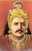 King Kharavela is serious, has black hair and a mustache, wearing a turban made of gold and precious gems such as rubies, diamonds, emeralds, and sapphire, wearing gold earrings, brown choghah, and jewelry.