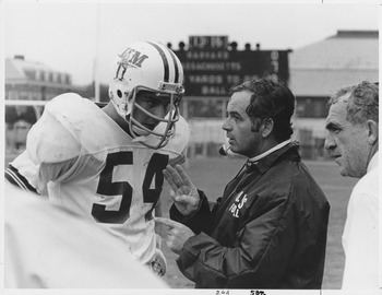 Bob Pickett Bob Pickett and Dick MacPherson talking with unidentified football