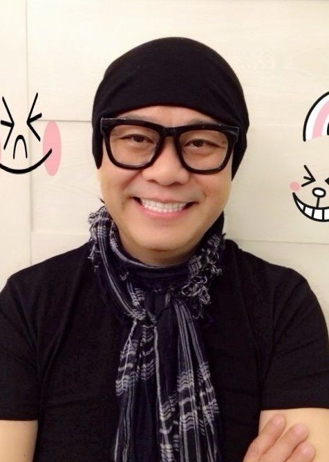 Bobby Au-yeung wearing a black beanie, checkered scarf, black shirt and eyeglasses