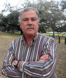 Bobby DeLaughter with mustache and wearing colorful striped long sleeves