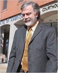 Bobby DeLaughter wearing gray coat, light yellow long sleeves and yellow neck tie