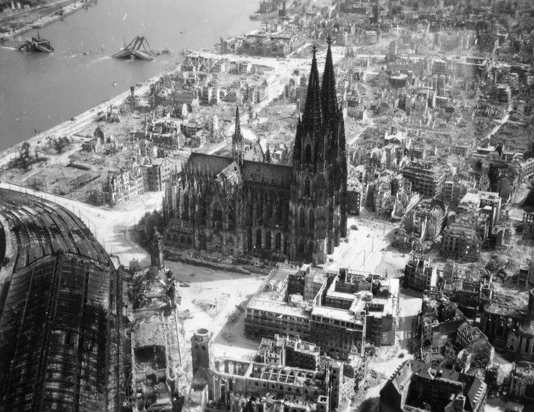 Bombing of Cologne in World War II The Cologne Cathedral stands tall amidst the ruins of the city after
