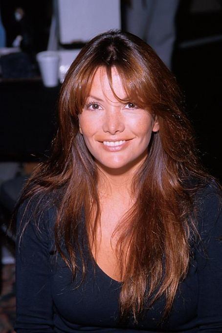Brandi Brandt, smiling, has brown hair and wearing a v neck black long sleeve top