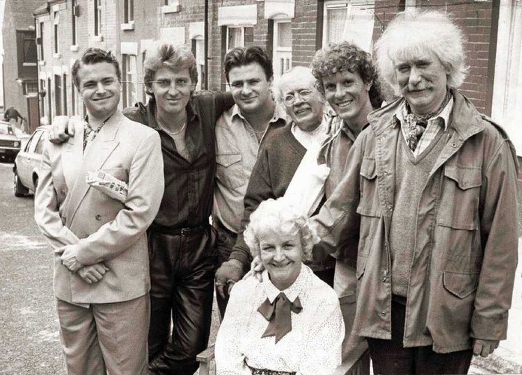 Casts of Bread, a British television sitcom: Nick Conway, Graham Bickley, Victor McGuire, Kenneth Waller, Jonathon Morris, and Ronald Forfar (top, from left to right) and Jean Boht (bottom).