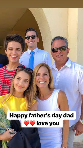 Brent Rivera smiling in a red and gray striped shirt together with his  family