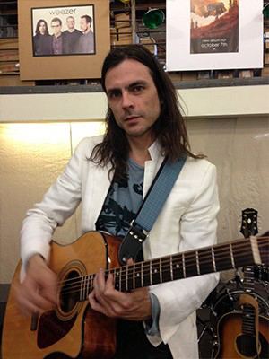 Brian Bell Brian Bell Of Weezer With GTO Strap Couch Guitar