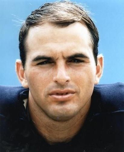 Brian Piccolo seriously looking at something and wearing a navy blue jersey