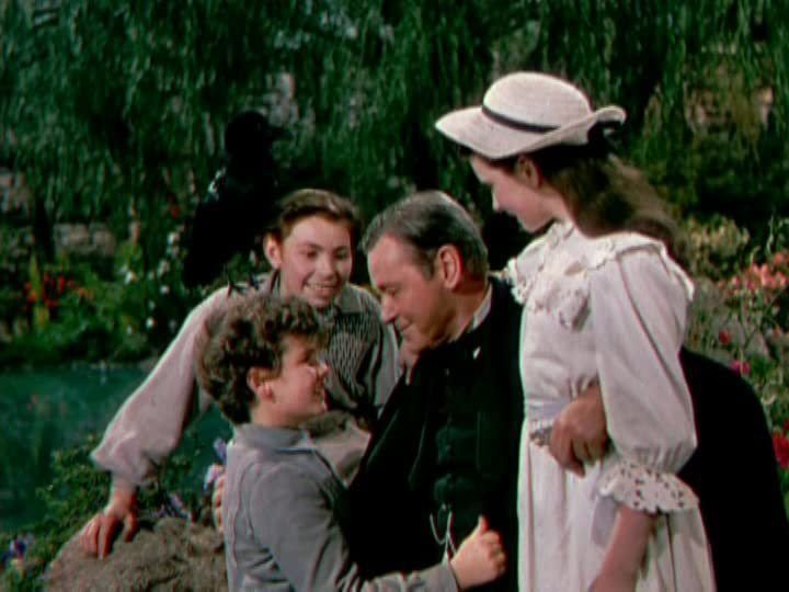 Brian Roper as Dickon with Dean Stockwell as Colin Craven with a black pigeon resting on his shoulder, Herbert Marshall as Archibald Craven, and Margaret O'Brien as Mary Lennox in a scene from the 1949 film "The Secret Garden"