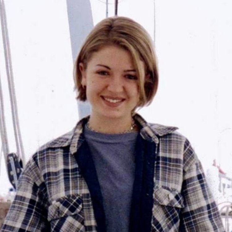 Bridgette Andersen smiling while wearing a checkered blazer and gray shirt