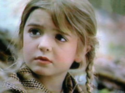 Bridgette Andersen with braided hair while wearing brown blouse