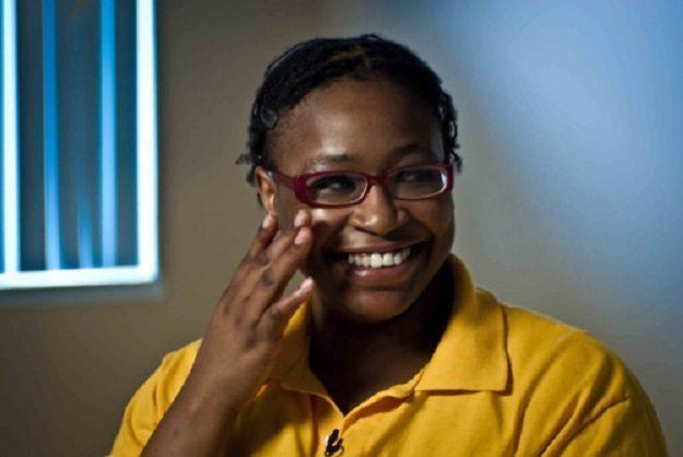 Brigitte Harris wearing a yellow shirt and a pair of eyeglasses