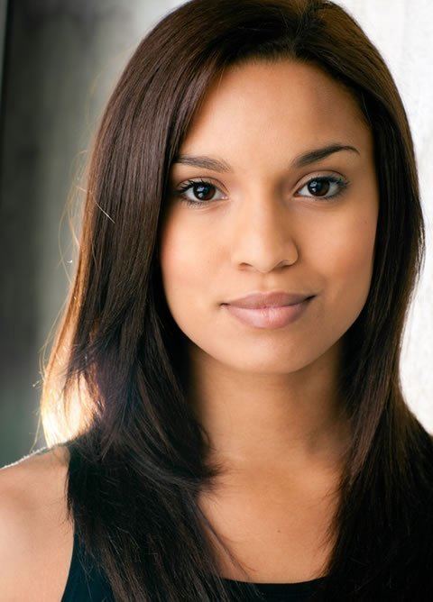 Brooke Marie Bridges smiling with straight brown hair and wearing a black blouse