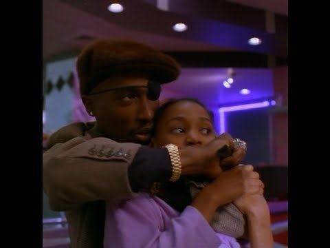 Tupak Shakor as Tank holding a woman by the neck as a hostage  in a scene from the 1996 film "Bullet"