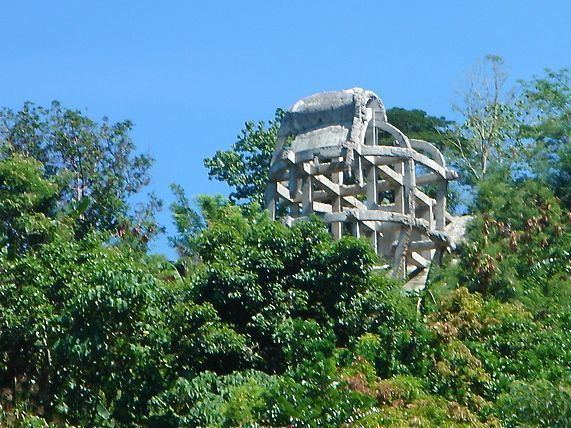 Bust of Ferdinand Marcos surrounded by trees