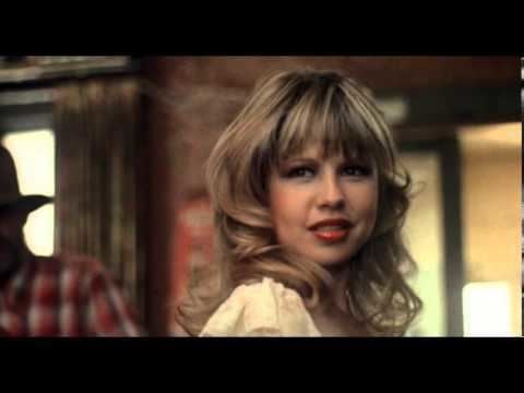 Pia Zadora smiling while wearing a white blouse in a scene from the 1982 American independent crime drama film, Butterfly