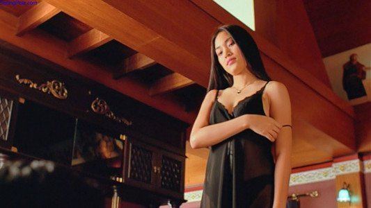 A woman wearing black lingerie in a movie scene from the 2002 Thai drama film Butterfly in Grey