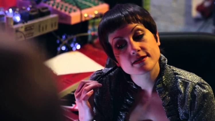 Nicolette le Faye wearing a black blazer in a scene from Call Girl of Cthulhu (2014 film)