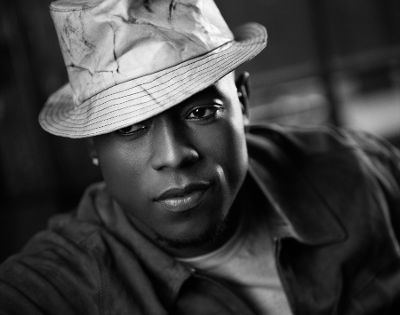 Calvin Richardson looking at the side while wearing a hat and sleeve in black and white