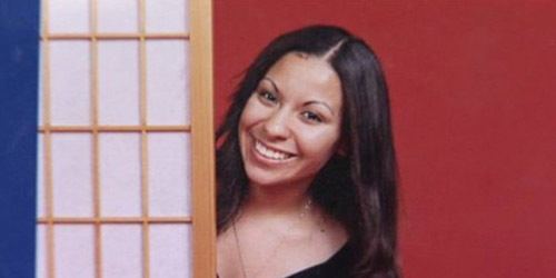 Candice Rose Martinez smiling while wearing a black blouse and necklace