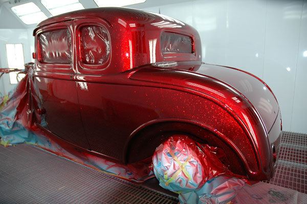 A car coated with candy apple red color and the wheels are covered with plastics