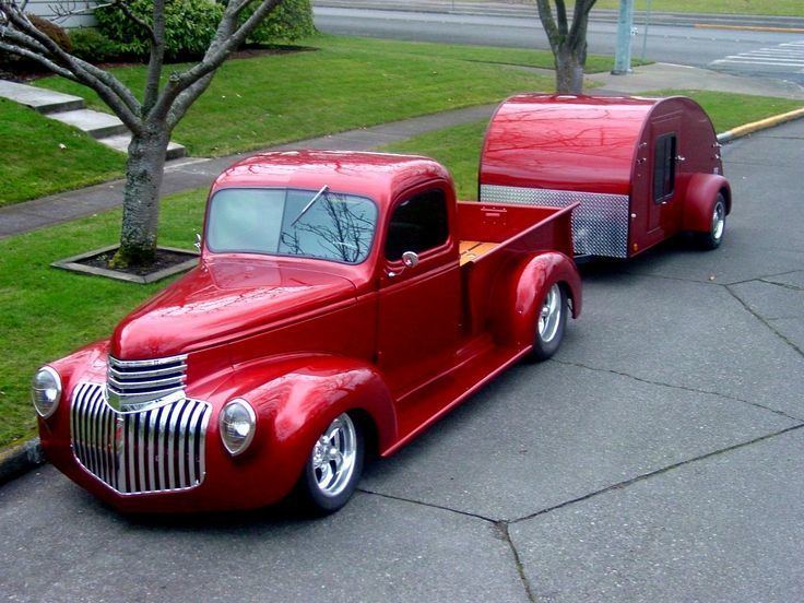 Chevrolet truck in Candy apple red color with two trees on the side