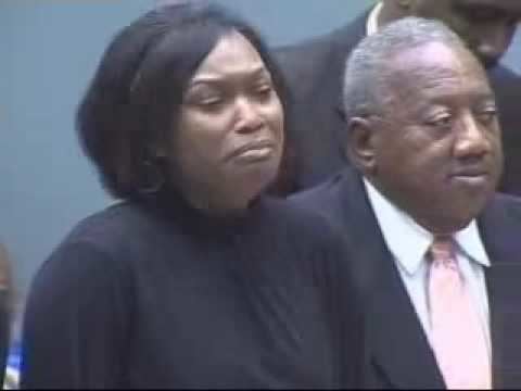 Carla Hughes crying in the trial court while wearing a black blouse