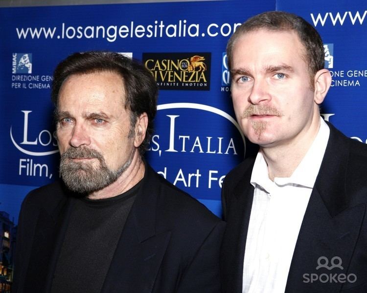 Carlo Gabriel Nero wearing black coat and white long sleeves while Franco Nero wearing a black coat and black shirt