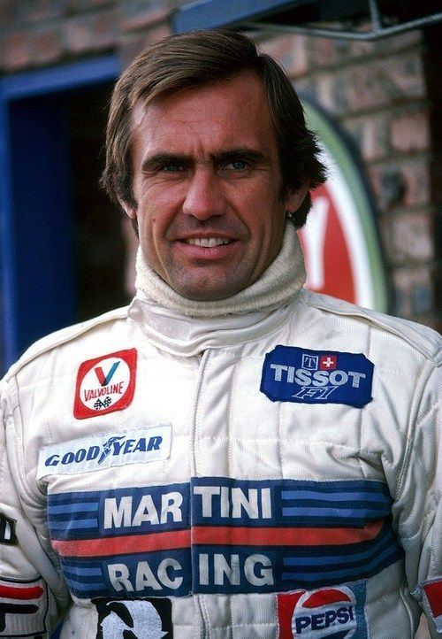 Carlos Reutemann smiling and wearing a racing suit