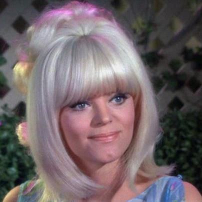 Carol Wayne smiling while wearing a blue top