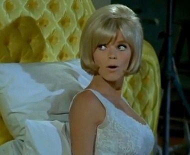 Carol Wayne with short blonde hair and wearing a white top
