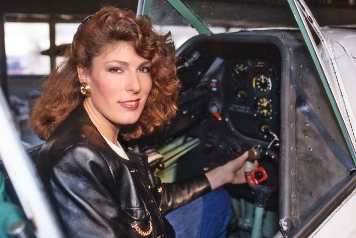 Carola Smit sitting inside an aircraft wearing a black leather jacket