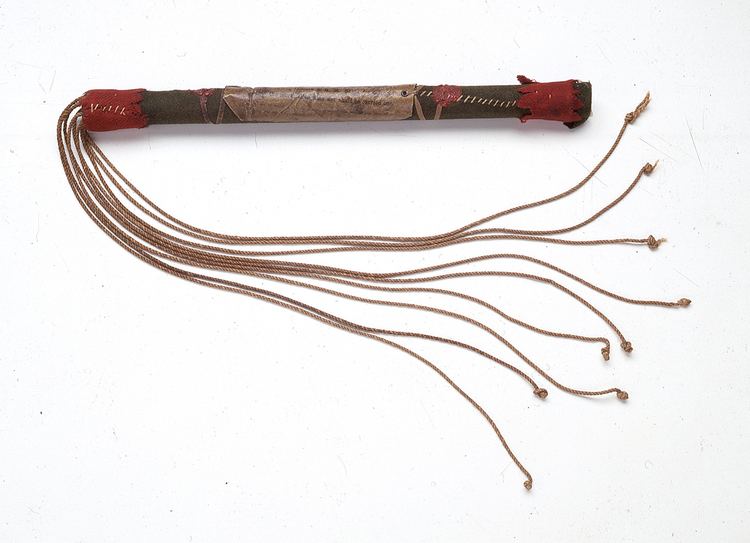 A Cat o' nine with brown tails and a red, black, and brown handle.