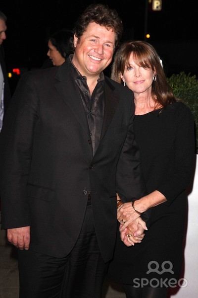 Cathy McGowan smiling and wearing a black dress with Michael Ball also smiling and wearing a black suit.