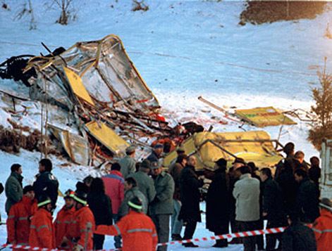 The damages caused by the 1998 Cavalese cable car disaster surrounded by rescuers and many people