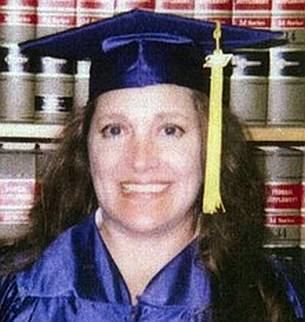 Celeste Beard smiling while wearing a blue academic dress